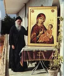 a man standing next to a painting